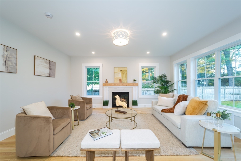 3 Ferndale Road Natick, MA 01760 - Photo 14 of 40 a living room with furniture a fireplace and a floor to ceiling window