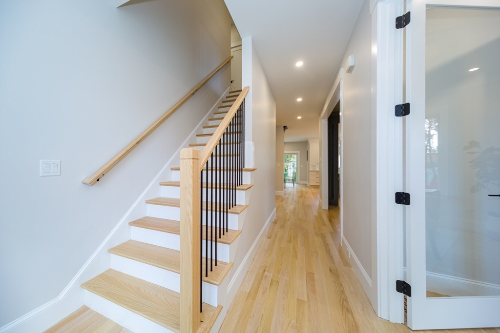 3 Ferndale Road Natick, MA 01760 - Photo 20 of 40 a view of a hallway with wooden floor and staircase