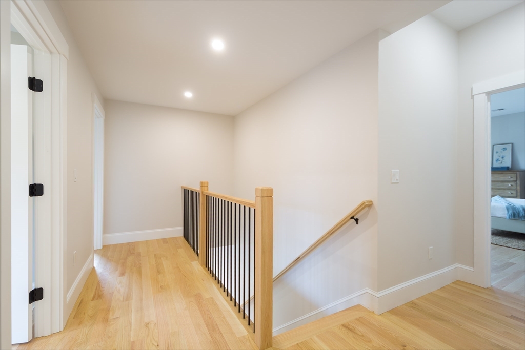 3 Ferndale Road Natick, MA 01760 - Photo 21 of 40 a view of a hallway with wooden floor and staircase