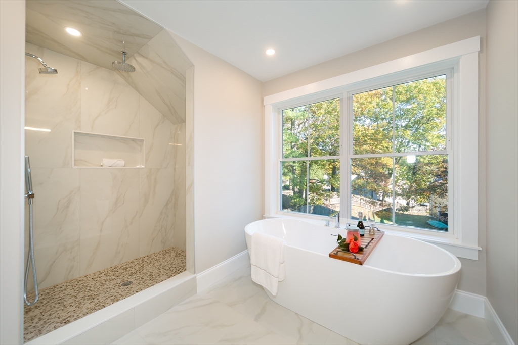 3 Ferndale Road Natick, MA 01760 - Photo 27 of 40 a white bath tub sitting in a bathroom next to a window