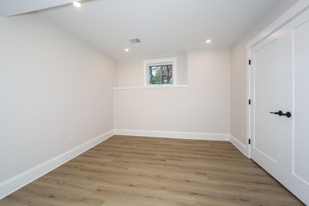 3 Ferndale Road Natick, MA 01760 - Photo 36 of 40 a view of an empty room with wooden floor and a window