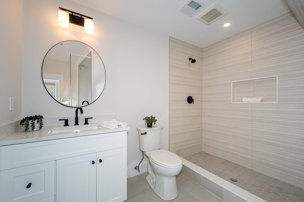 3 Ferndale Road Natick, MA 01760 - Photo 37 of 40 a bathroom with a toilet a sink a mirror and shower