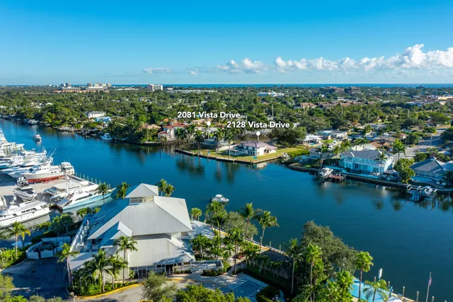 an aerial view of a city with lots of residential buildings lake and ocean view