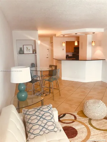 a living room with a bed and a lamp with wooden floor