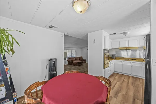 a kitchen with a refrigerator and a stove top oven