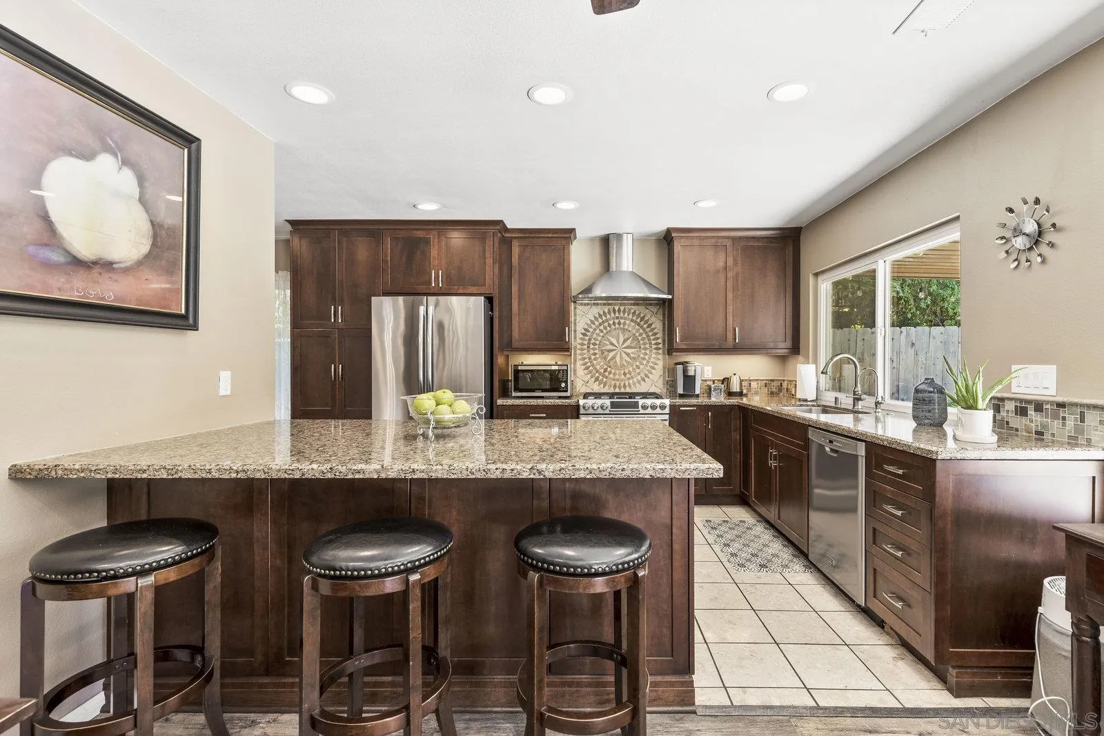 14152 Kendra Way Poway, CA 92064 - Photo 12 of 42 a kitchen with stainless steel appliances granite countertop a sink and chairs