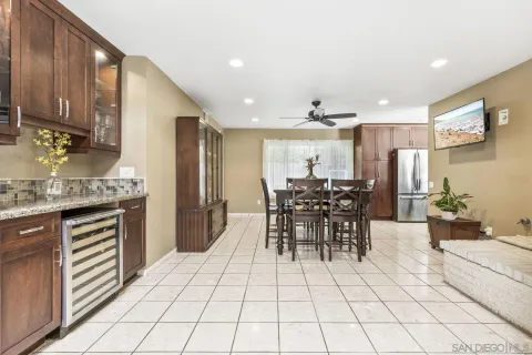 a kitchen with stainless steel appliances kitchen island granite countertop a refrigerator and cabinets