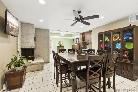 a view of a dining room with furniture and a potted plant