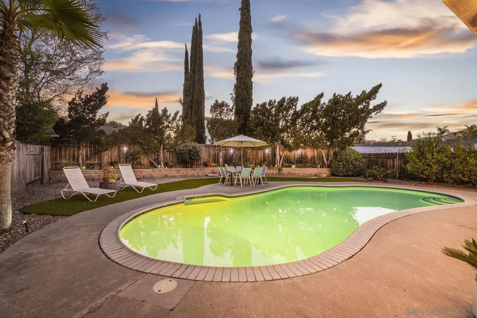 14152 Kendra Way Poway, CA 92064 - Photo 31 of 42 a view of a swimming pool with a yard and sitting area
