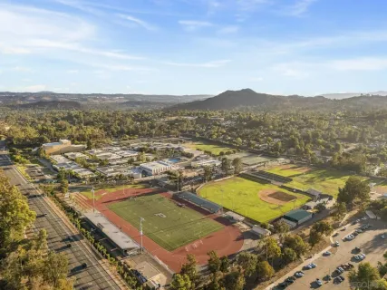 an aerial view of residential houses with outdoor space and swimming pool