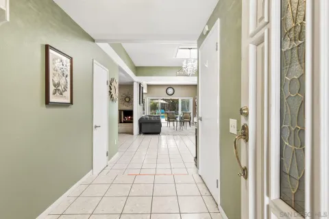 a hallway with a large mirror next to a window