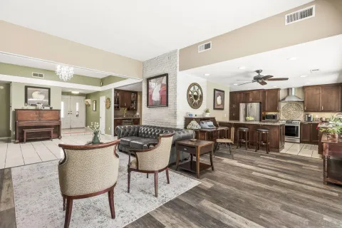 a living room with furniture and kitchen view