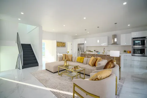 a kitchen with stainless steel appliances kitchen island granite countertop a sink and cabinets