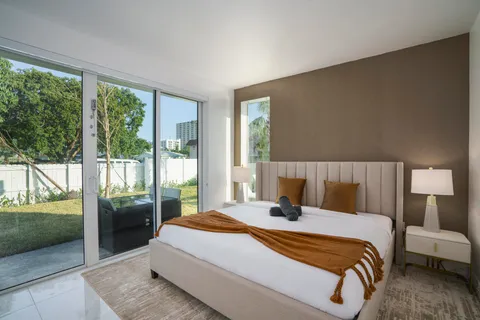 a bathroom with a double vanity sink a mirror and shower