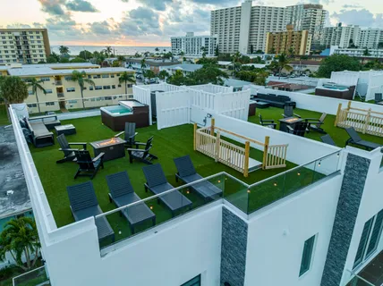 a view of a swimming pool with outdoor seating and plants