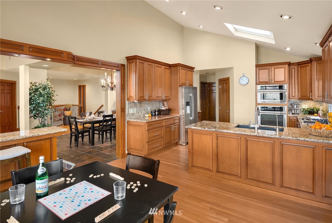 16005 Inglewood Road Northeast Kenmore, WA 98028 - Photo 18 of 39 a view of a dining room with furniture window and wooden floor