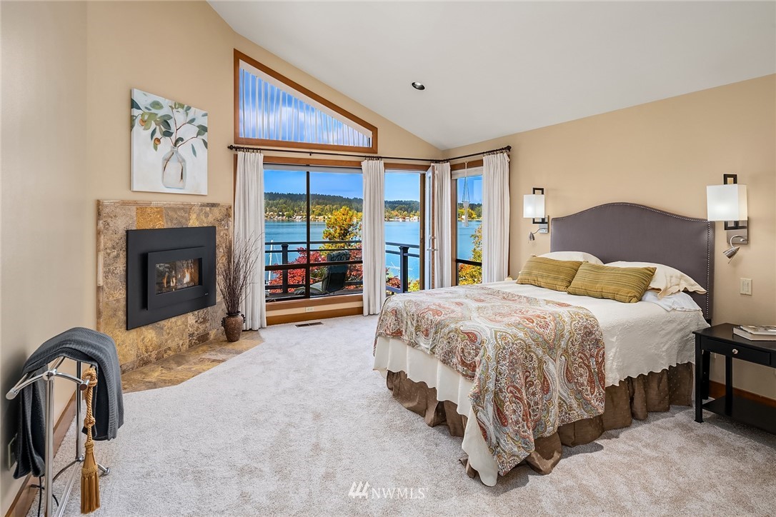 16005 Inglewood Road Northeast Kenmore, WA 98028 - Photo 21 of 39 a spacious bedroom with a bed and a fireplace