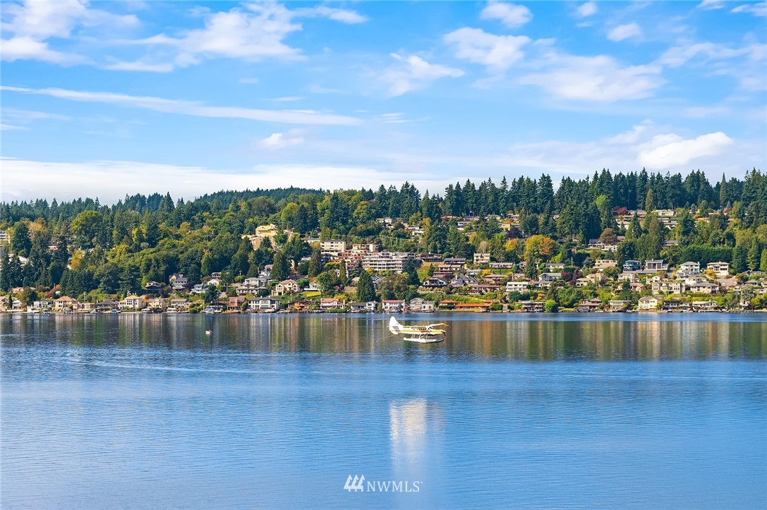 16005 Inglewood Road Northeast Kenmore, WA 98028 - Photo 24 of 39 a view of a lake with boats and trees in the background