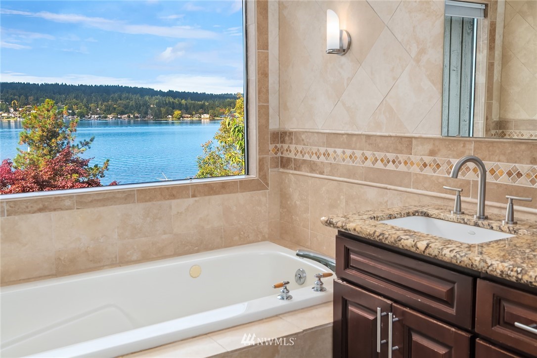 16005 Inglewood Road Northeast Kenmore, WA 98028 - Photo 27 of 39 a backyard of a house with plants and tree