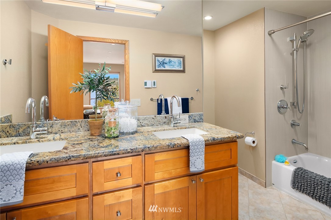 16005 Inglewood Road Northeast Kenmore, WA 98028 - Photo 29 of 39 a bathroom with a granite countertop sink a toilet and shower