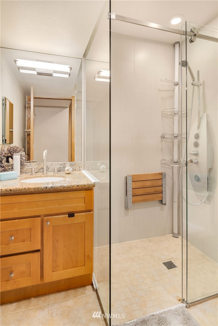 16005 Inglewood Road Northeast Kenmore, WA 98028 - Photo 31 of 39 a bathroom with a shower sink and mirror