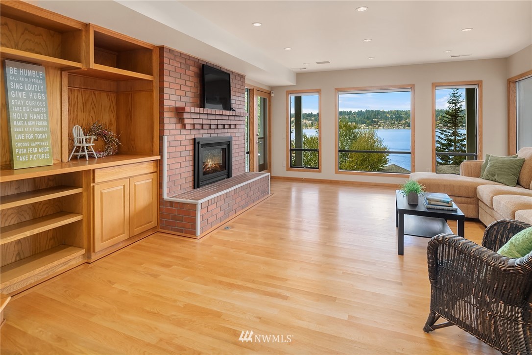 16005 Inglewood Road Northeast Kenmore, WA 98028 - Photo 32 of 39 a living room with furniture a flat screen tv and a fireplace