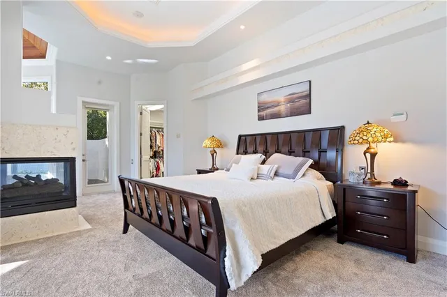 a bedroom with a bed and a fireplace