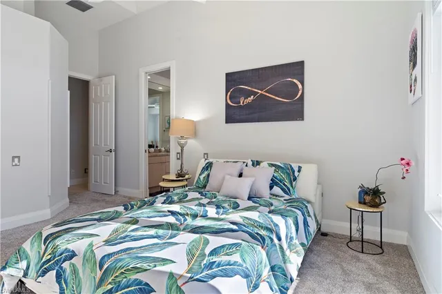 a bedroom with a bed and painting on the wall