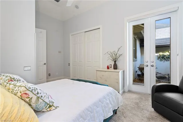 a bedroom with a large bed and a chair