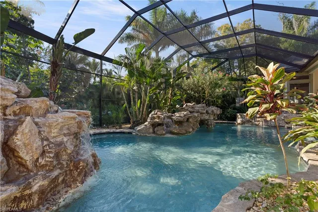 a view of a patio with table and chairs under an umbrella