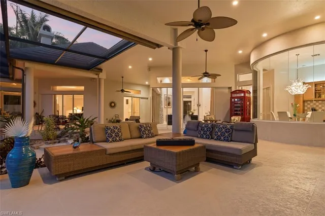 a living room with furniture ceiling fan and a rug