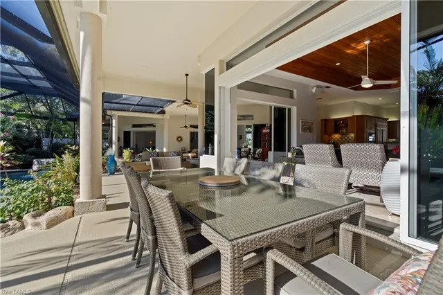a view of a dining room with furniture and chandelier