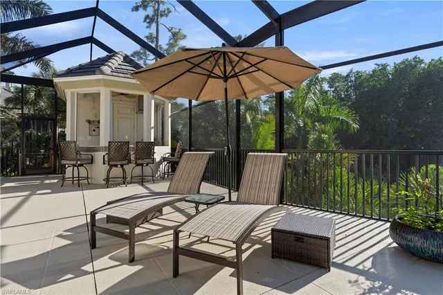 a view of a patio with a table chairs and a umbrella