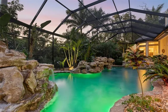 a view of a swimming pool with a patio and a yard