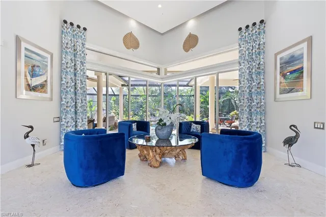 a living room with furniture and a floor to ceiling window