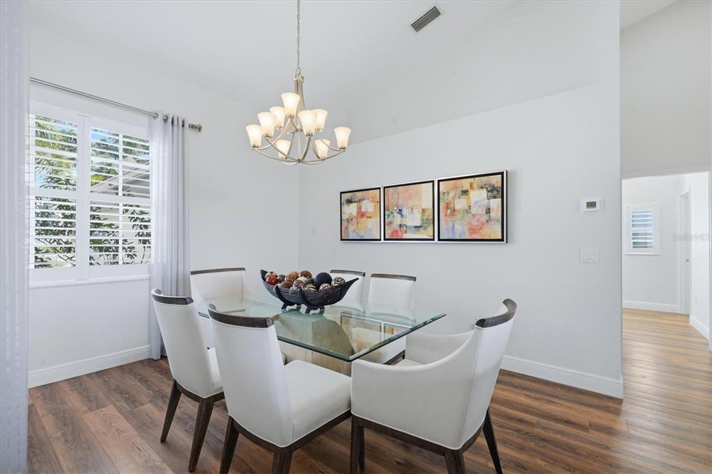 14402 Bridgeview Lane Port Charlotte, FL 33953 - Photo 20 of 93 a view of a dining room with furniture wooden floor and a chandelier