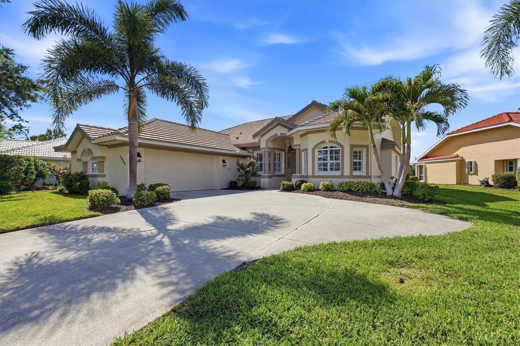 14402 Bridgeview Lane Port Charlotte, FL 33953 - Photo 2 of 93 a front view of a house with a yard and garage