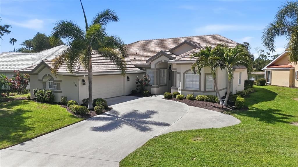 14402 Bridgeview Lane Port Charlotte, FL 33953 - Photo 4 of 93 a front view of a house with a yard and garage