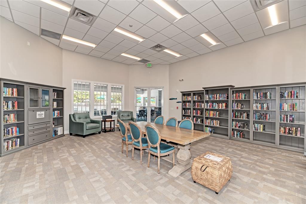 14402 Bridgeview Lane Port Charlotte, FL 33953 - Photo 75 of 93 a living room with furniture and a book shelf