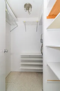 a bedroom with a bed and a potted plant