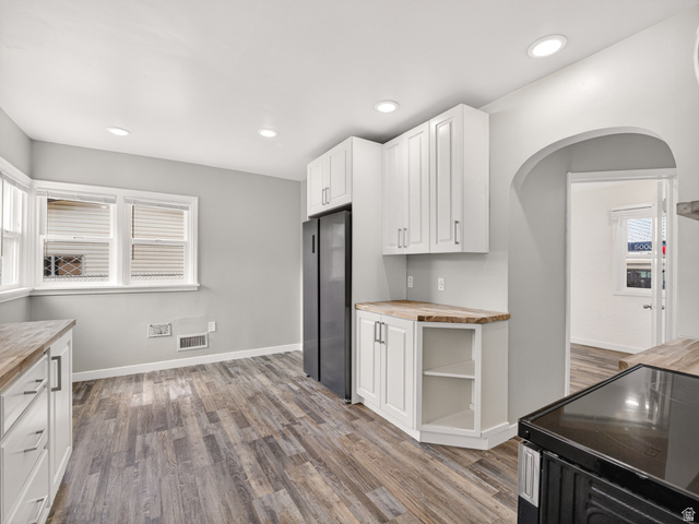 74 South 300 East Springville, UT 84663 - Photo 11 of 48 Kitchen featuring white cabinetry, wood-finish countertops, black appliances, recessed lighting, and wood-finish flooring