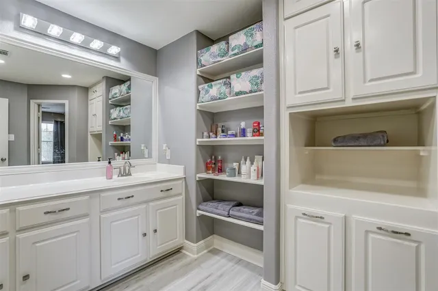 a spacious bathroom with a double vanity sink and a mirror