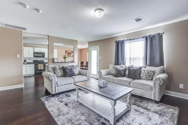 a living room with furniture and a large window