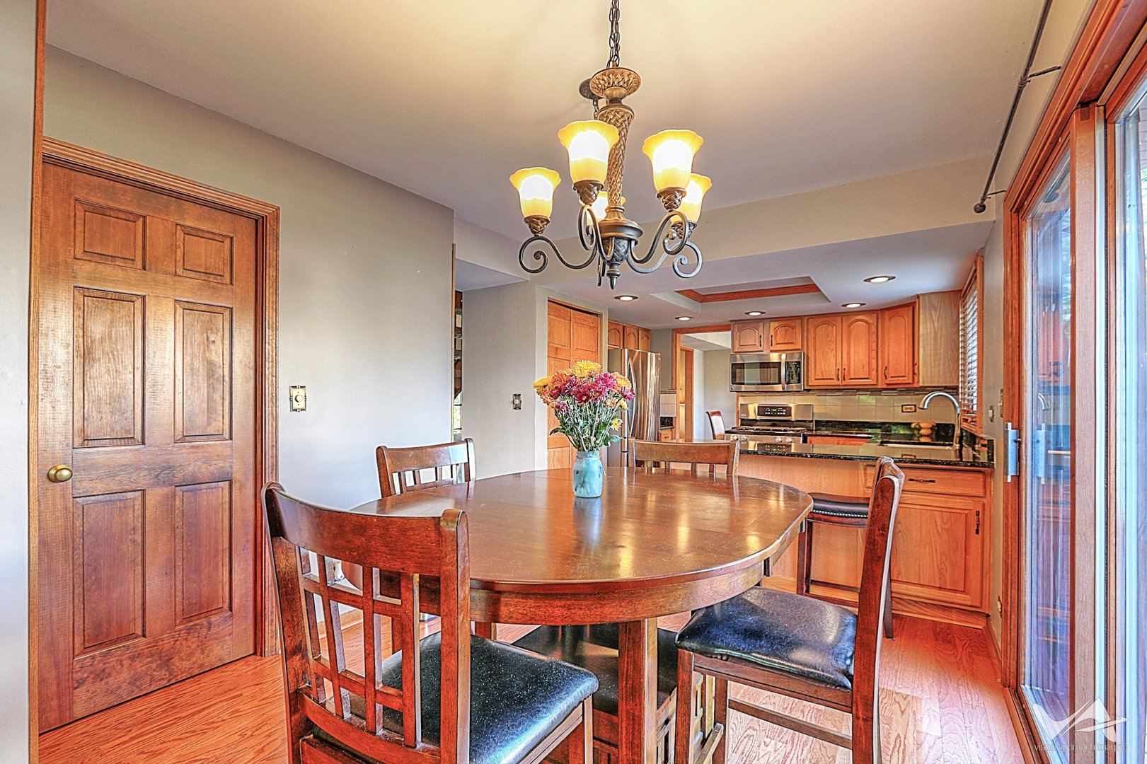 1034 Fall Circle Roselle, IL 60172 - Photo 11 of 30 a dining room with furniture a chandelier and wooden floor