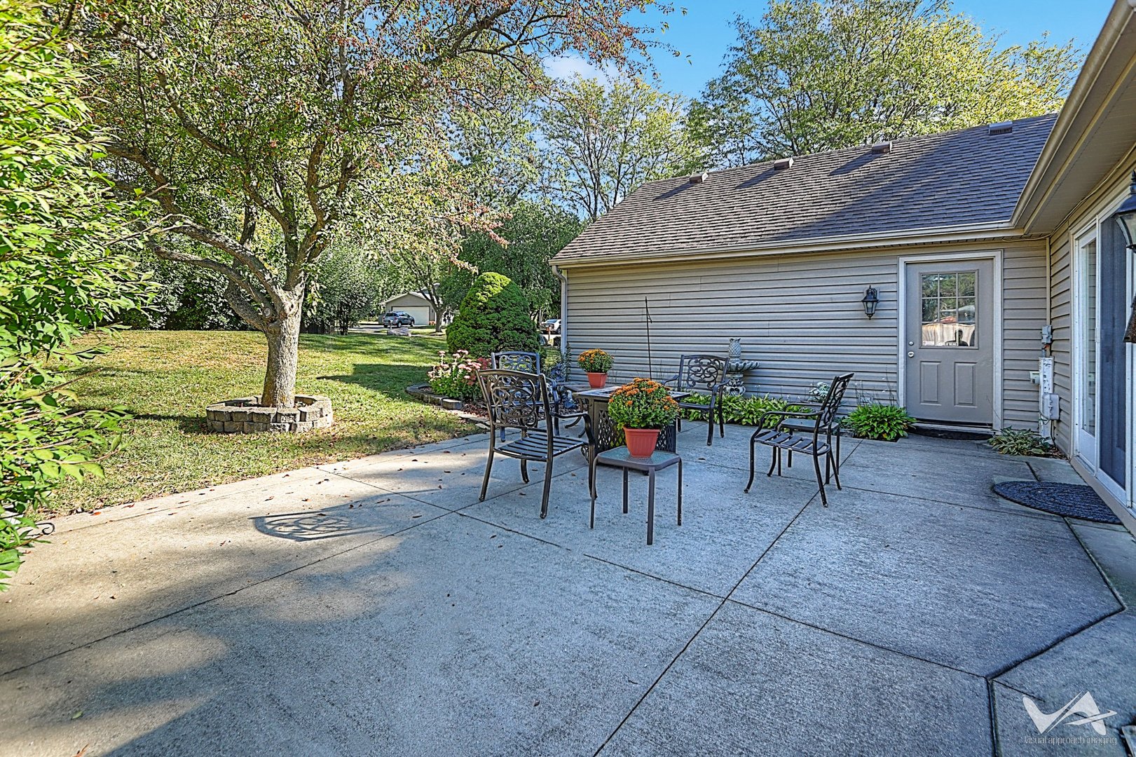 1034 Fall Circle Roselle, IL 60172 - Photo 26 of 30 a view of a patio with table and chairs under an umbrella