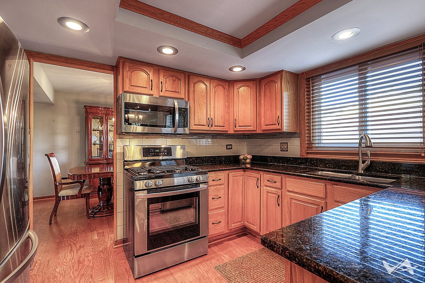1034 Fall Circle Roselle, IL 60172 - Photo 9 of 30 a kitchen with stainless steel appliances granite countertop a stove a sink and a microwave