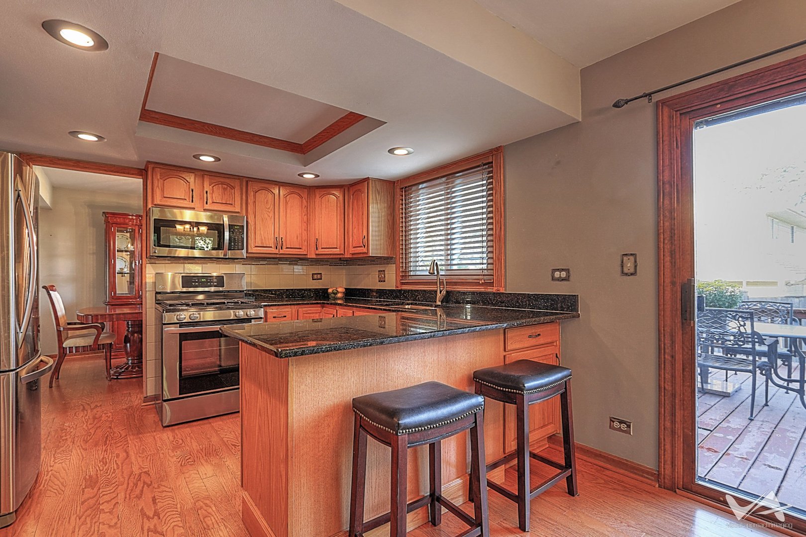 1034 Fall Circle Roselle, IL 60172 - Photo 10 of 30 a kitchen with stainless steel appliances granite countertop a stove top oven a sink and a refrigerator