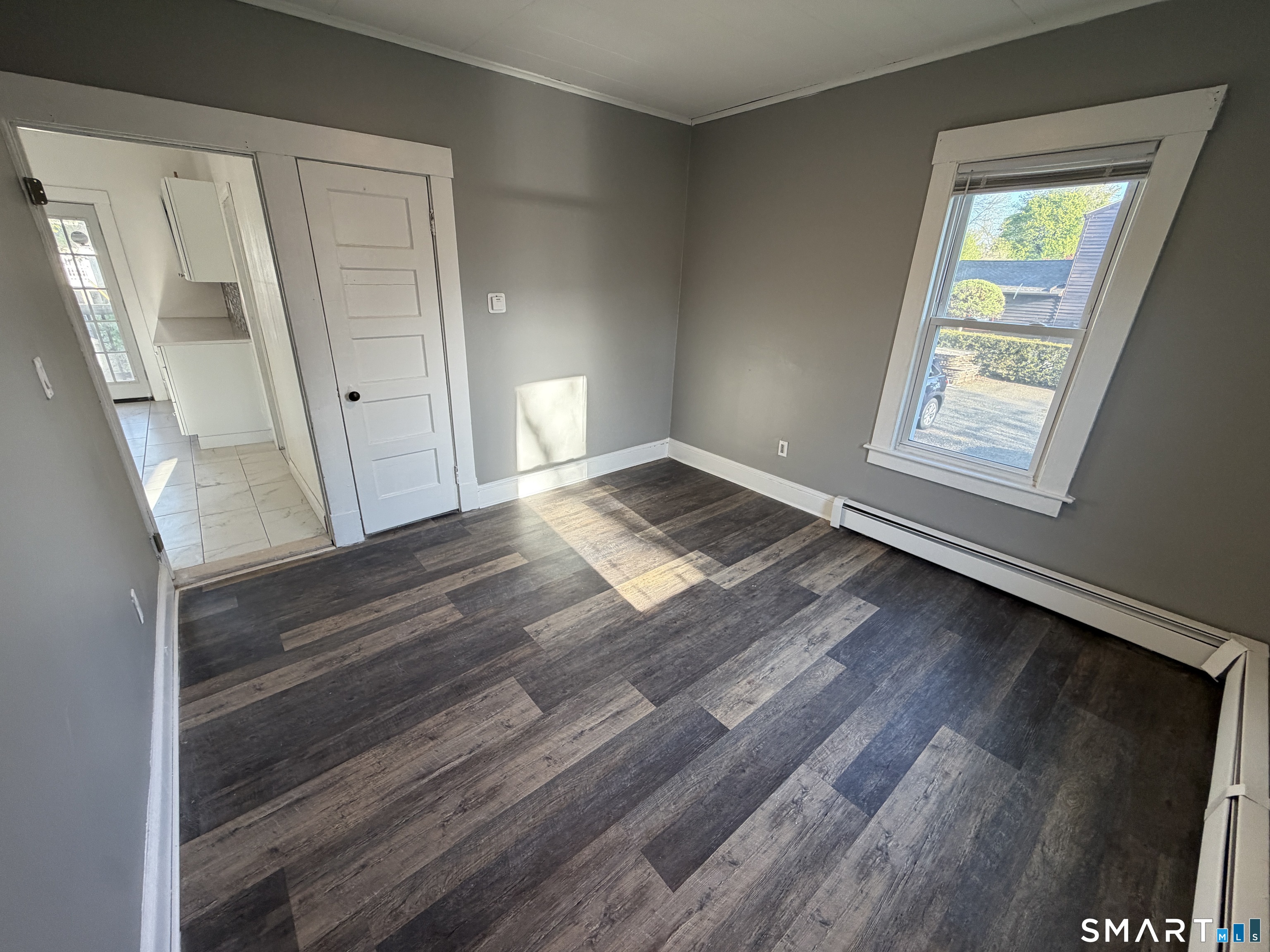 402 Allen Street New Britain, CT 06053 - Photo 11 of 14 a view of an empty room with wooden floor and a window