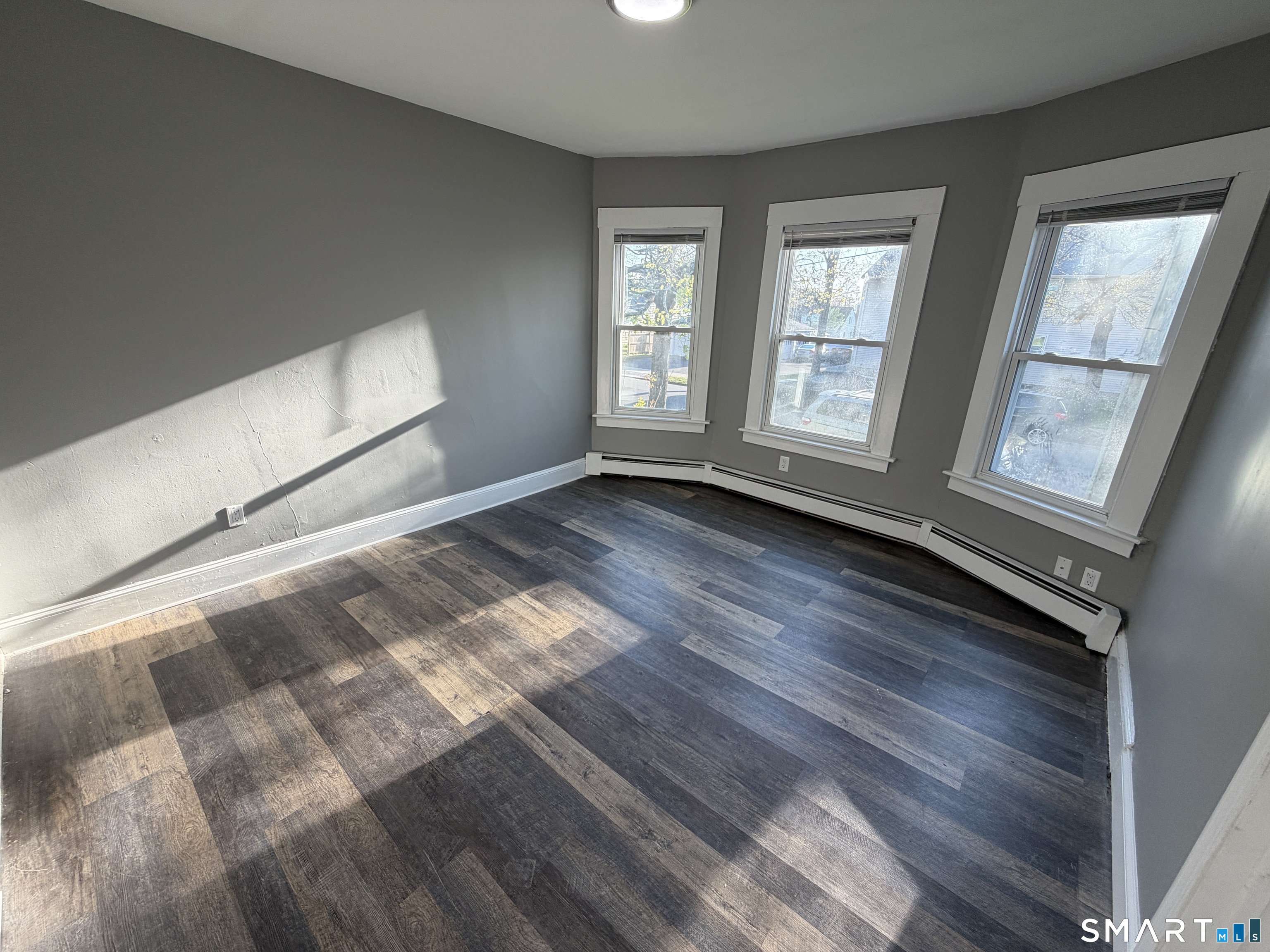 402 Allen Street New Britain, CT 06053 - Photo 13 of 14 a view of an empty room with wooden floor and a window