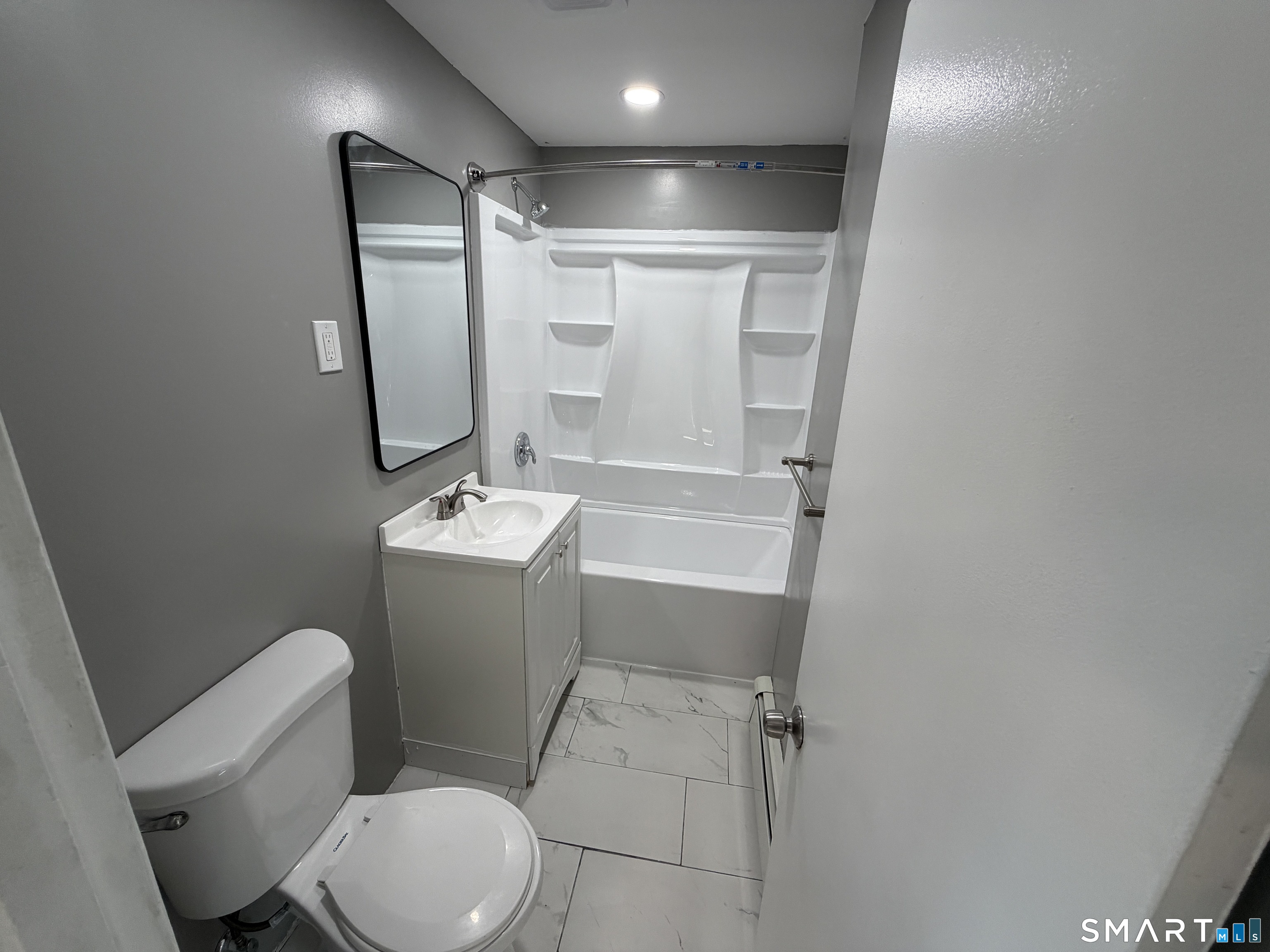 402 Allen Street New Britain, CT 06053 - Photo 9 of 14 a bathroom with a sink a toilet a mirror and shower